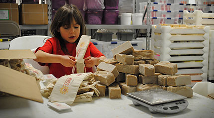 Child bagging soap for family's e-commerce business