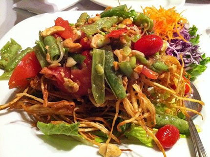 Celebrating small businesses by eating a plate of Thai fried papaya salad from a small, locally-owned restaurant in San Francisco.