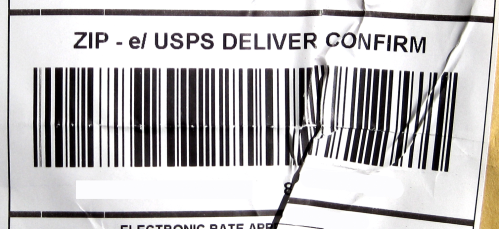 Image shows folds and creases on the barcode of a shipping label.